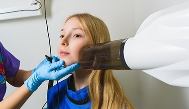 Preteen girl receiving dental x-rays